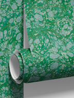 Roll detail of Milano Gemma wallpaper by Ashley Woodson Bailey, an ornate marble in emerald and seafoam, like light coming through green glass.